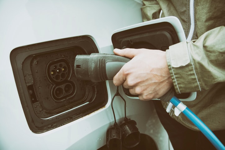 Male Hand Charging The Electric Car